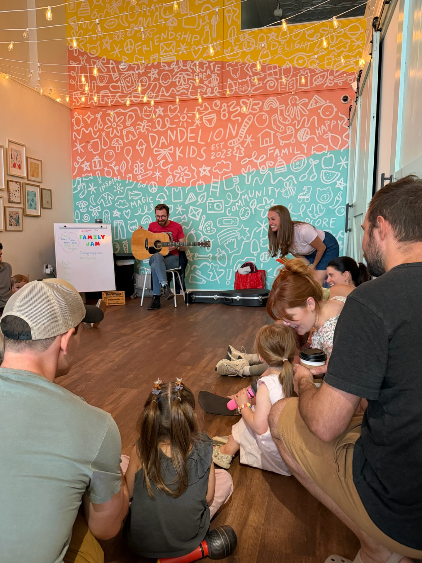 Families gathered on the floor for a Family Jam class with live guitar